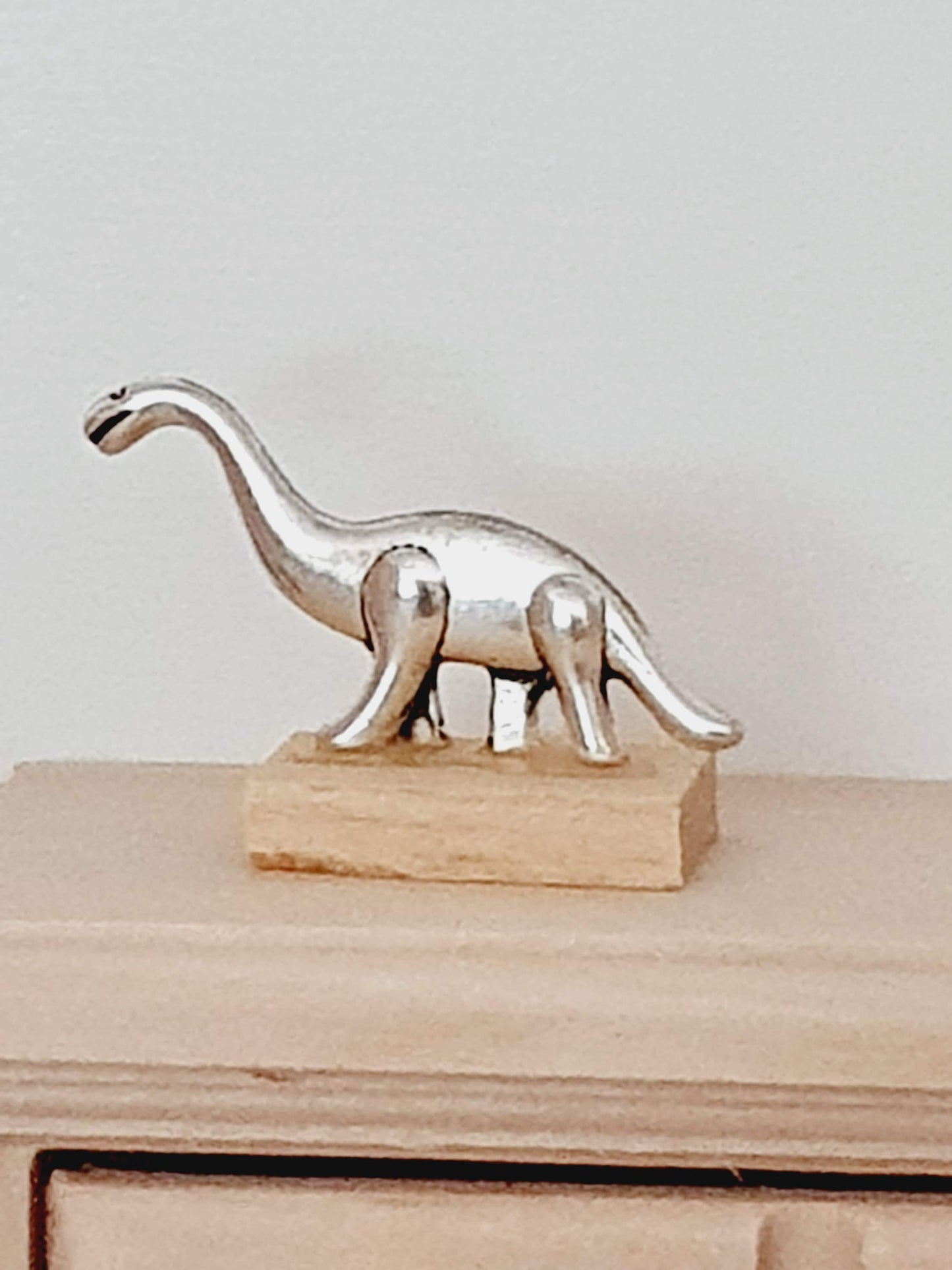 Dolls House Small Dinosaur Ornament on a wooden stand, 1:12th Scale, Miniature dino on a stand