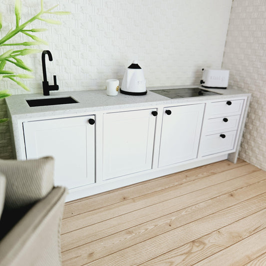 dollhouse modern kitchen unit, 3 white cupboards, 3 white drawers, wood effect cutlery tray, black knob handles, grey waterfall worktop, black sink and tap, black induction hob, 3d printed, 12th scale Measures W: 20.6cm, D: 5.4cm H: 7.5cm
