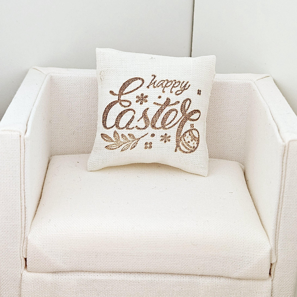 dollhouse cushion, 3cm, cream with gold writing with happy easter, cushion has an easter egg on it, 12th scale, miniature cushion