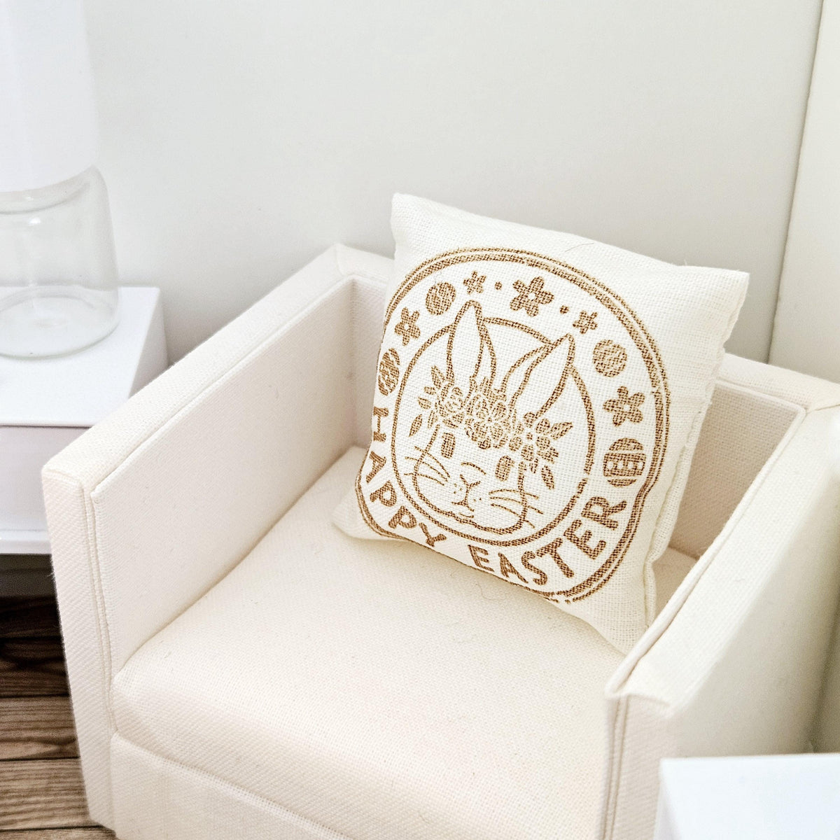 dollhouse cushion, 4cm, cream with gold writing with happy easter and a bunny face in a circle on a square cushion, 12th scale, miniature cushion