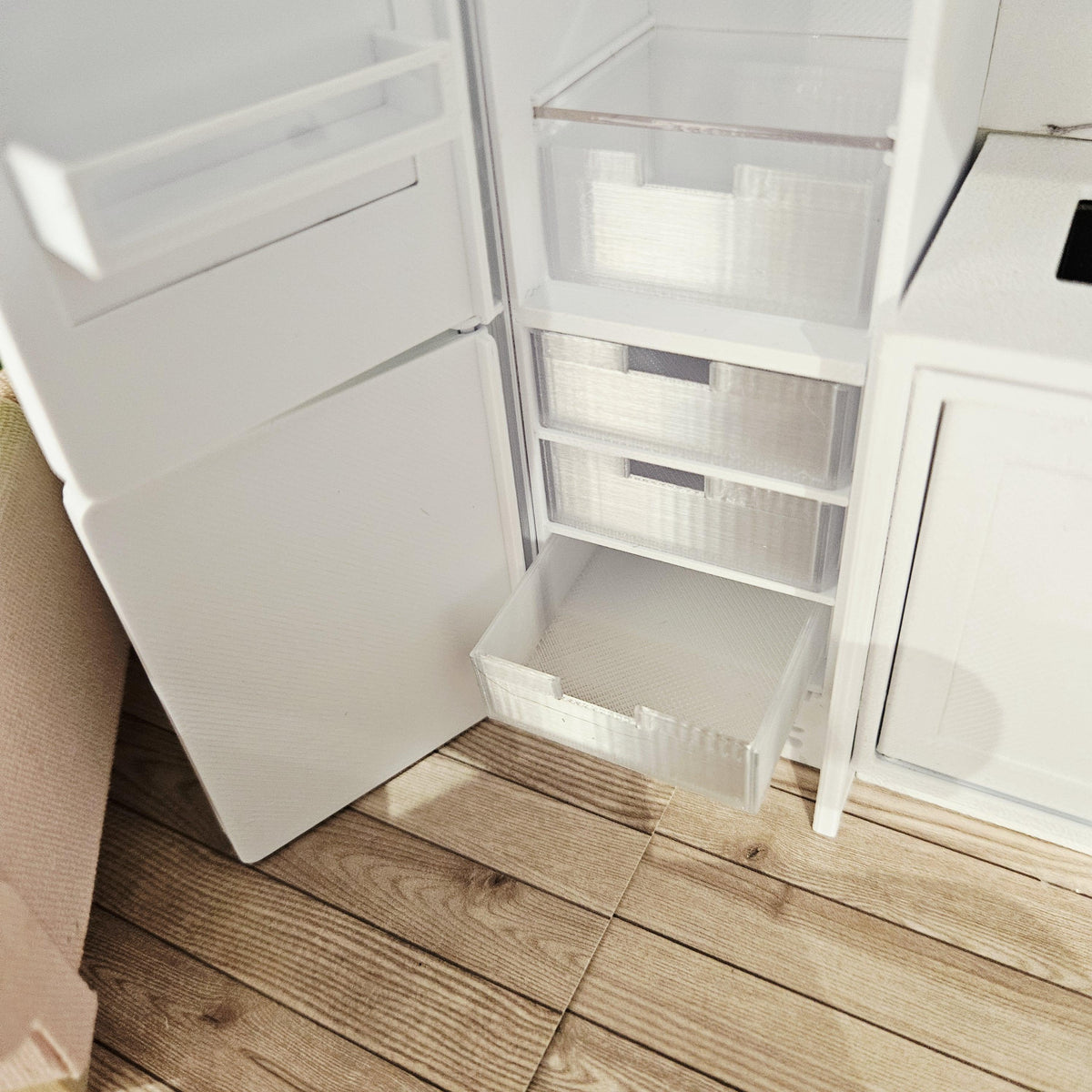 Three freezer drawers inside the open lower section of the 1:12 scale fridge freezer