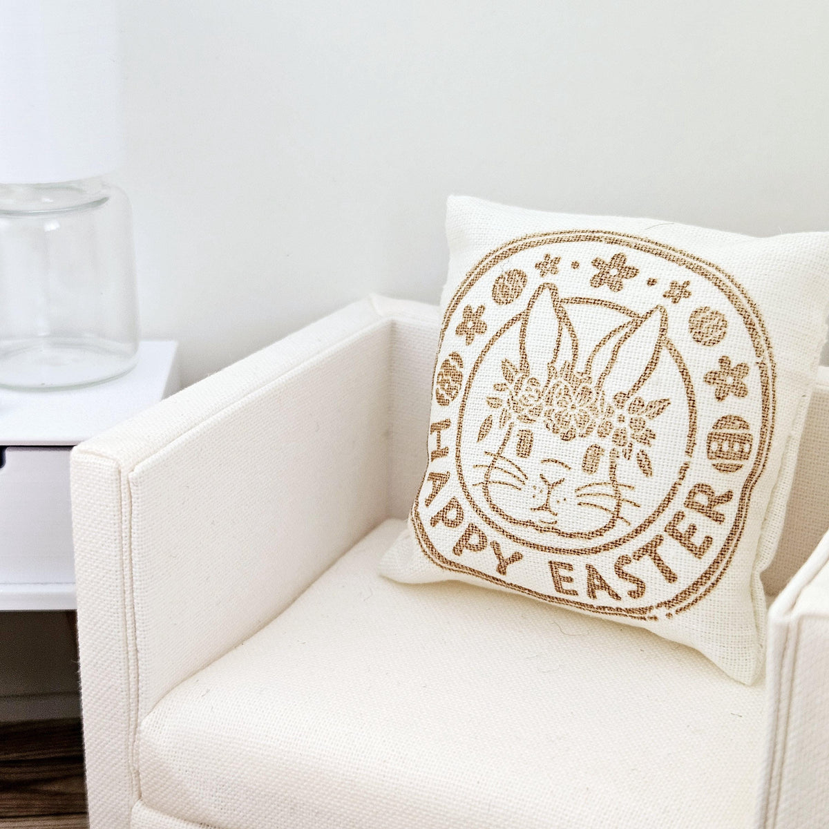 dollhouse cushion, 4cm, cream with gold writing with happy easter and a bunny face in a circle on a square cushion, 12th scale, miniature cushion