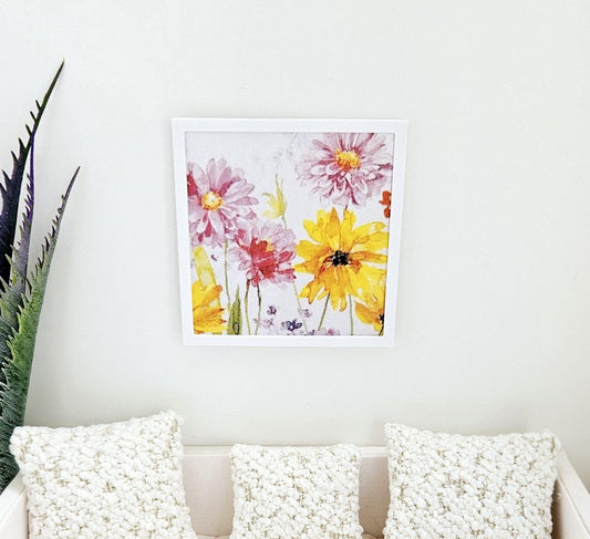 May include: A framed watercolour painting of pink and yellow flowers with green stems on a white background.