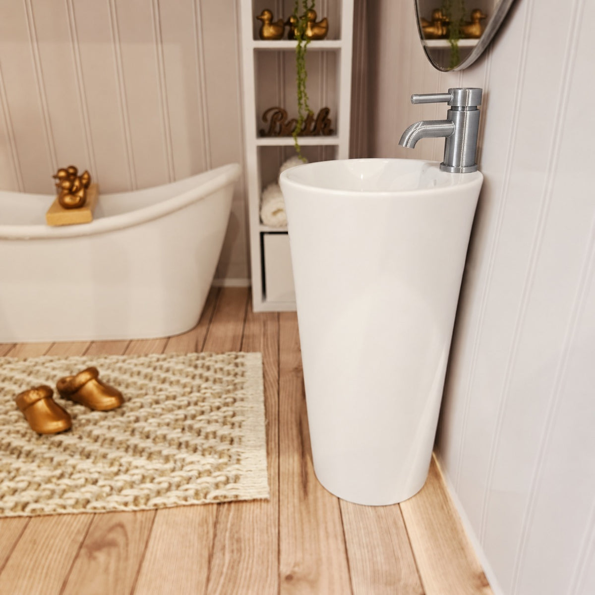 Wider bathroom view showing white miniature sink with silver tap