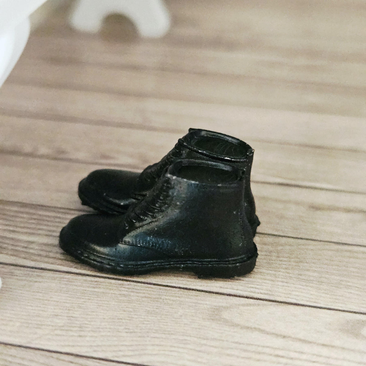 Black dm style boots – one pair in a 1:12 scale dolls house display, detail view