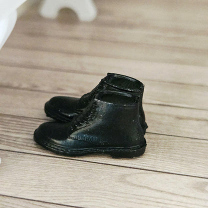 Black dm style boots – one pair in a 1:12 scale dolls house display, detail view
