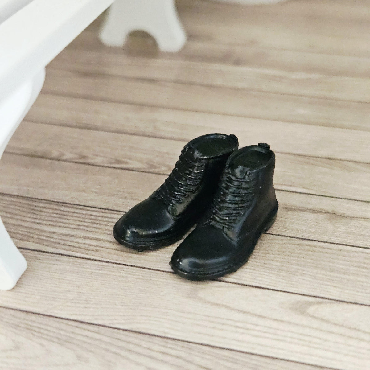 Black dm style boots – one pair in a 1:12 scale dolls house display, detail view