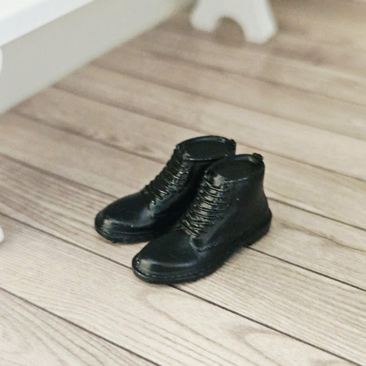 Black dm style boots – one pair in a 1:12 scale dolls house display, detail view