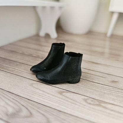 Black chelsea boots – one pair in a 1:12 scale dolls house display, detail view