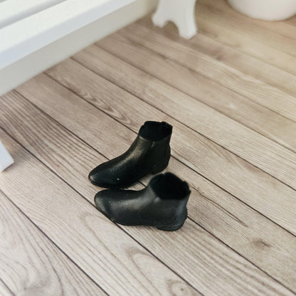 Black chelsea boots – one pair in a 1:12 scale dolls house display, detail view