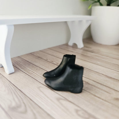 Black chelsea boots – one pair in a 1:12 scale dolls house display, detail view