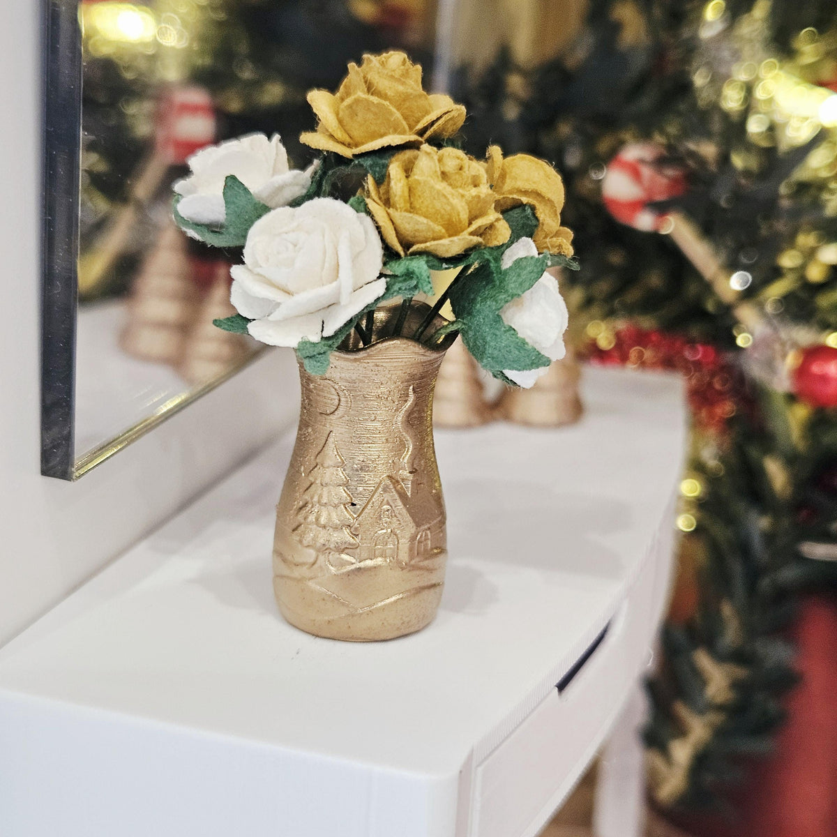 Gold Christmas scene vase with gold and white roses on a dolls house sideboard, 1:12 scale