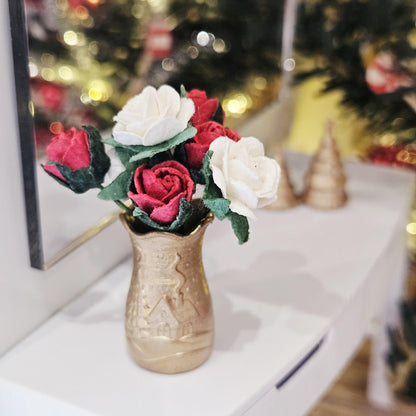 Gold Christmas scene vase with red and white roses on a dolls house sideboard, 1:12 scale