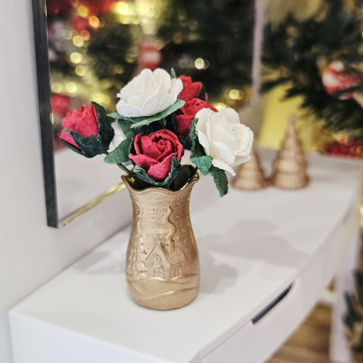 Gold Christmas scene vase with red and white roses on a dolls house sideboard, 1:12 scale