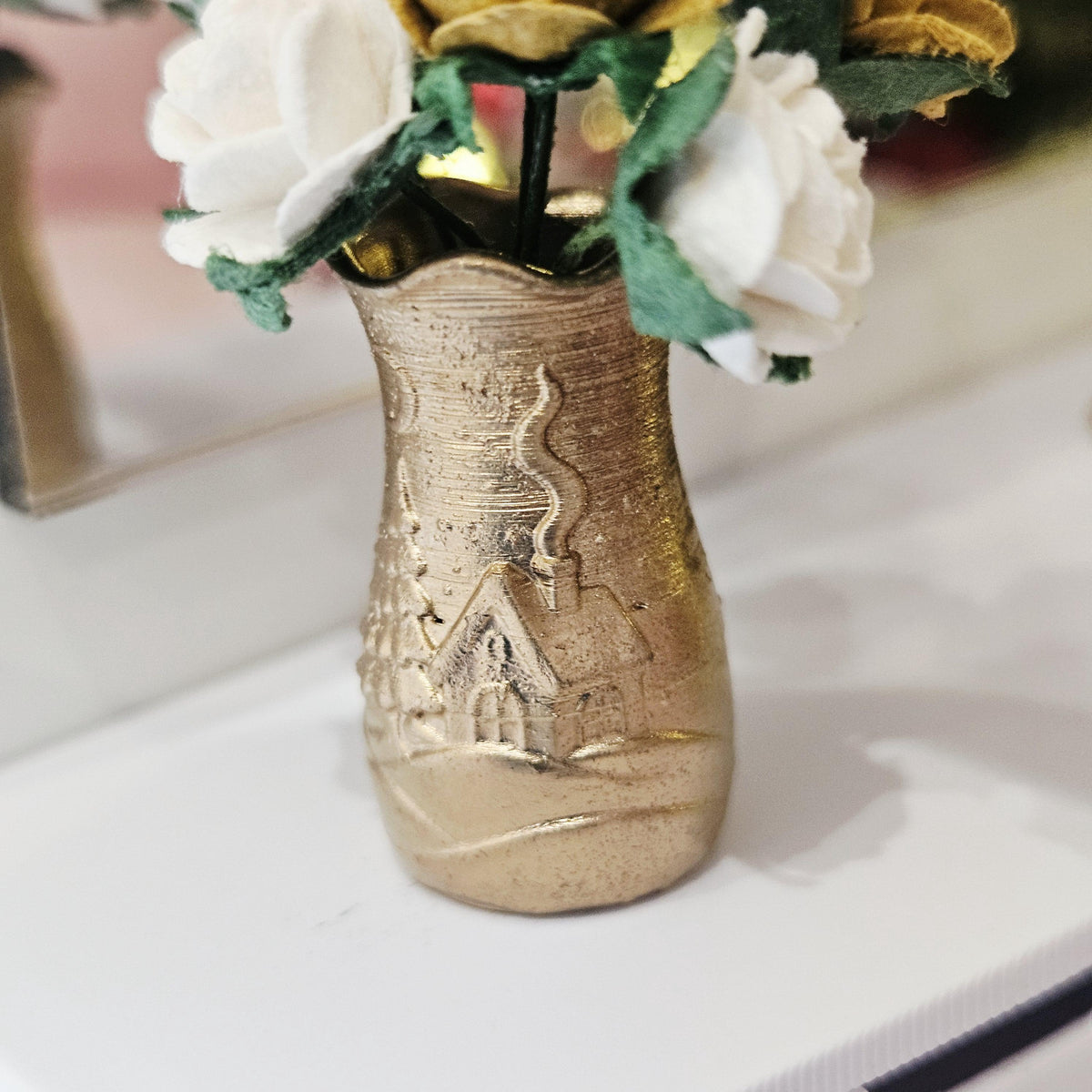 Gold Christmas scene vase with gold and white roses on a dolls house sideboard, 1:12 scale