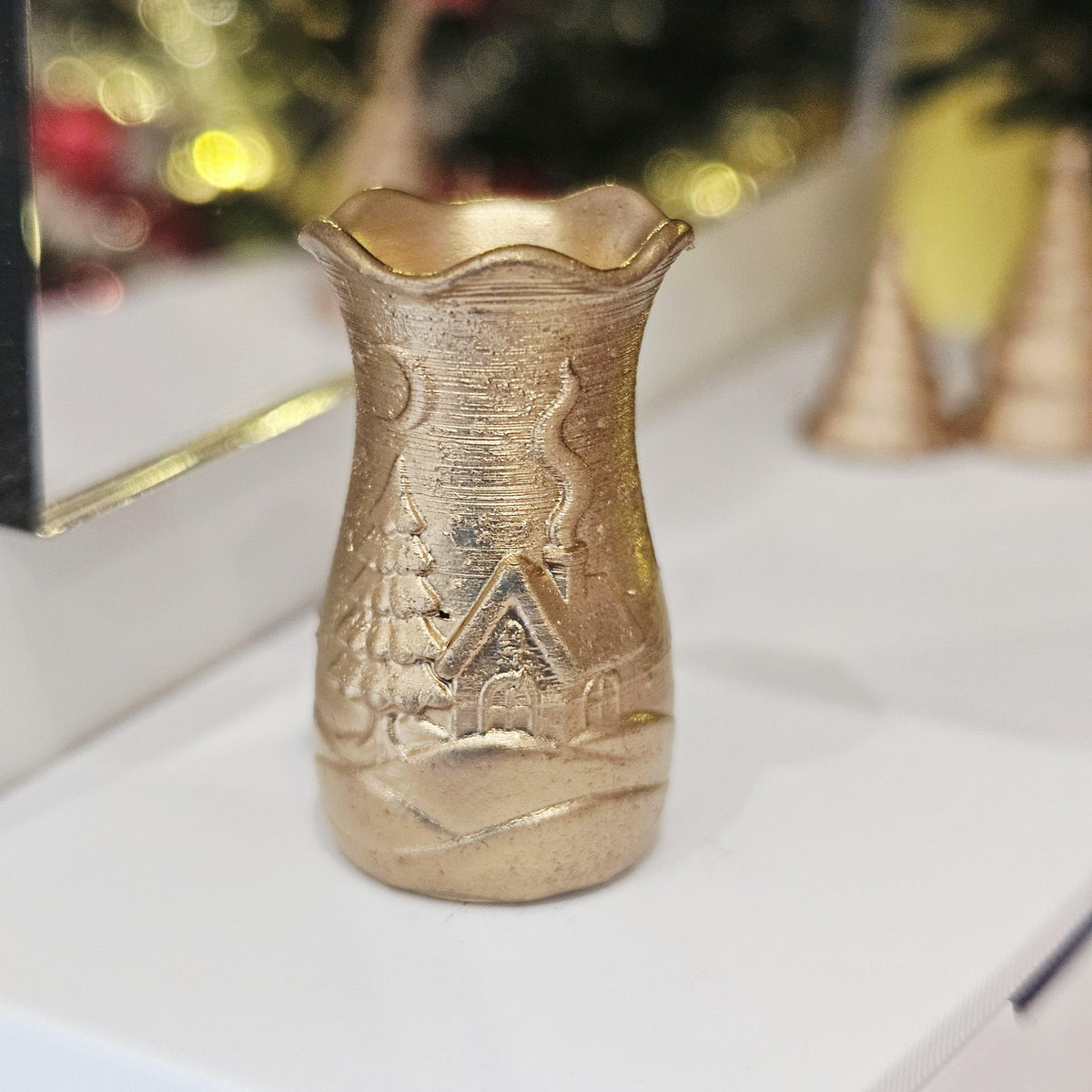 Gold flared christmas scene vase in a 1:12 scale dolls house display