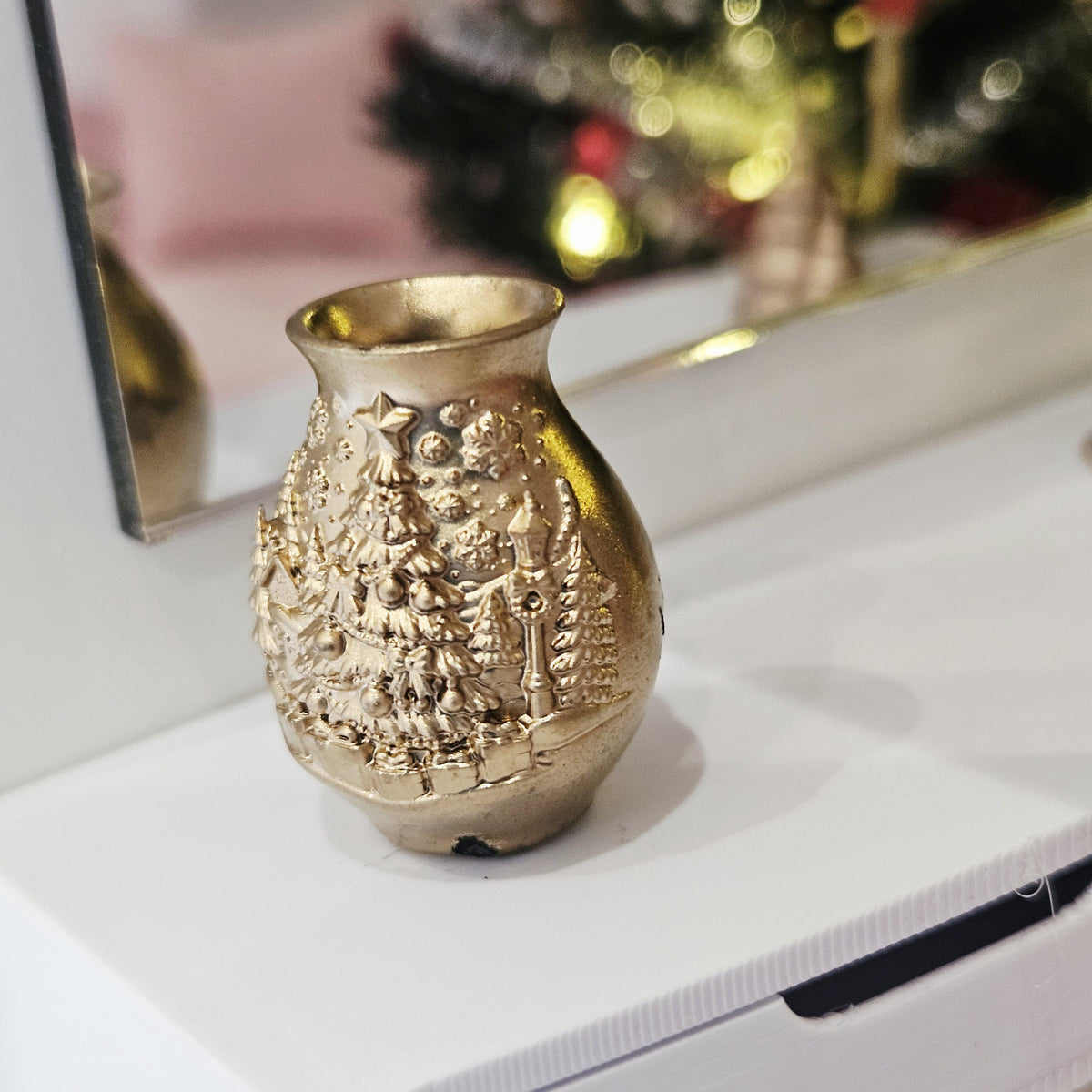 Gold christmas tree vase in a 1:12 scale dolls house display, detail view