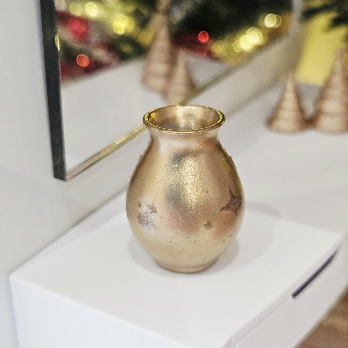Gold christmas tree vase in a 1:12 scale dolls house display, detail view