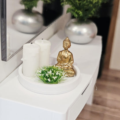 Gold Buddha ornament with two white candles and a white-flowering plant on a white tray, 1:12 scale dolls house