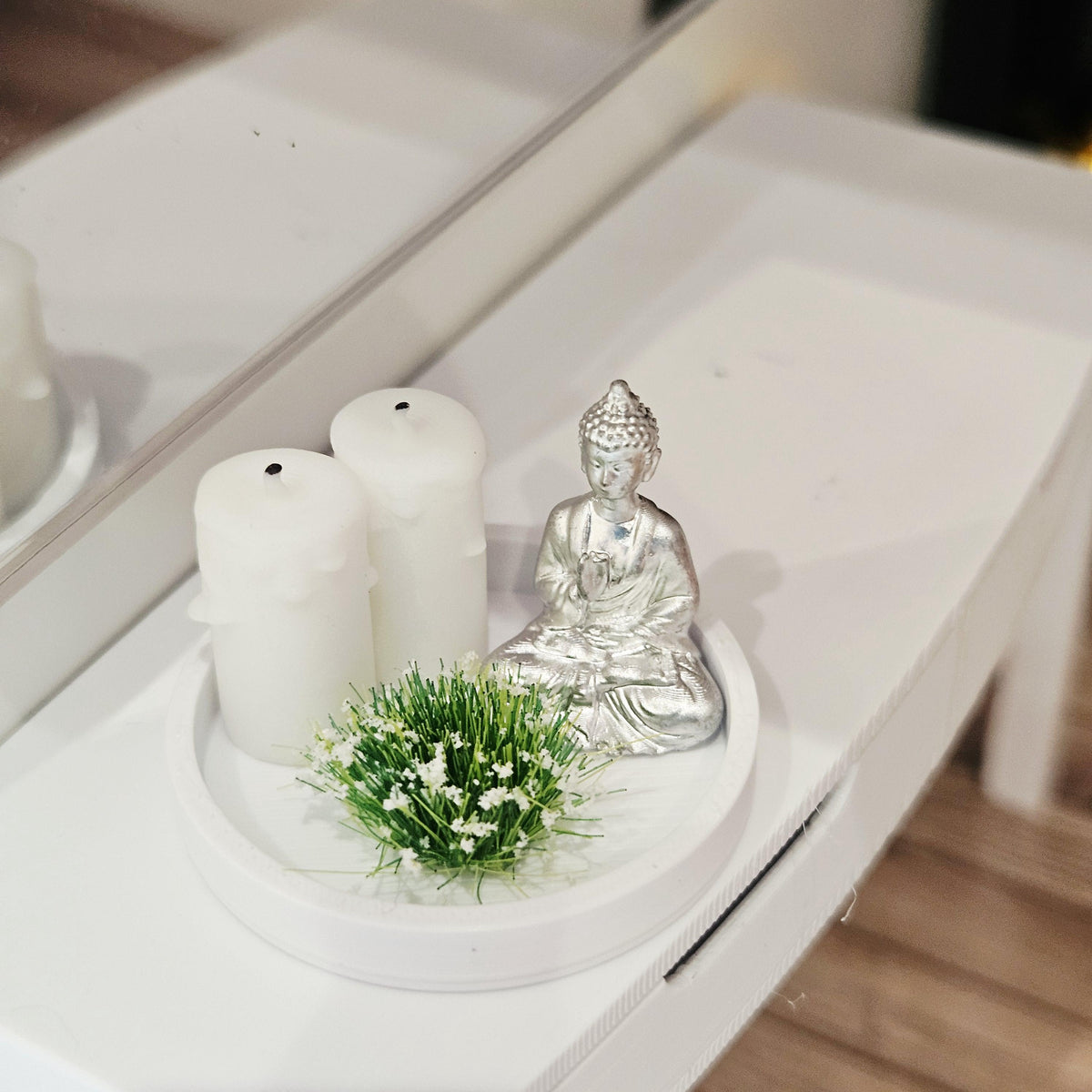 Silver Buddha ornament with two white candles and a white-flowering plant on a white tray, 1:12 scale dolls house