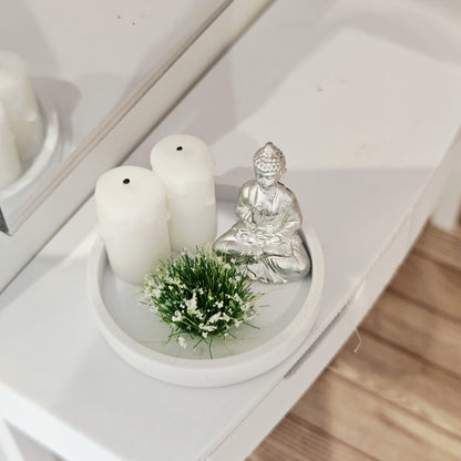 Silver Buddha ornament with two white candles and a white-flowering plant on a white tray, 1:12 scale dolls house