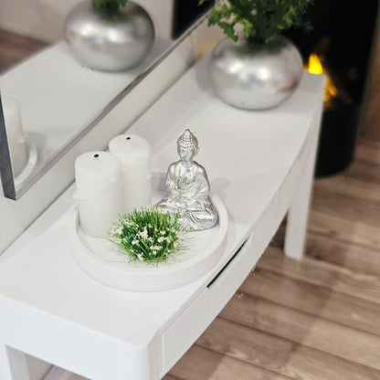 Silver Buddha ornament with two white candles and a white-flowering plant on a white tray, 1:12 scale dolls house