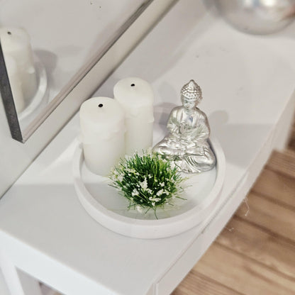 Silver Buddha ornament with two white candles and a white-flowering plant on a white tray, 1:12 scale dolls house