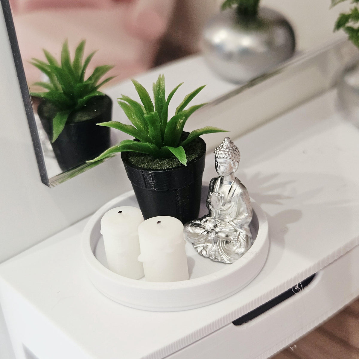 Silver Buddha, two white candles and a green plant in a black pot on a white tray, 1:12 scale dolls house