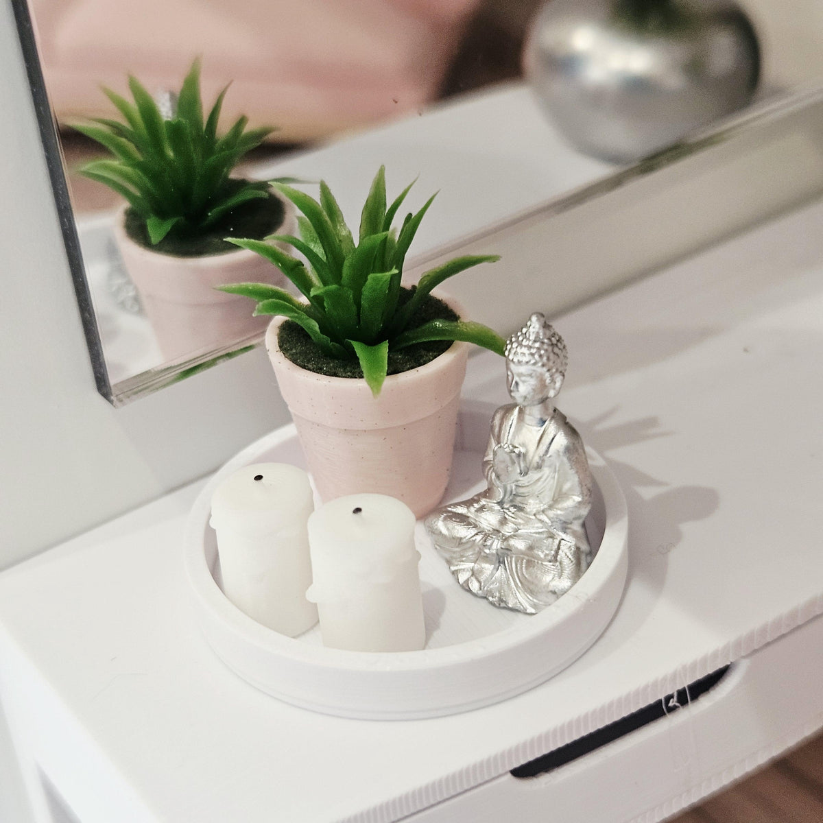 Silver Buddha, two white candles and a green plant in a pink pot on a white tray, 1:12 scale dolls house