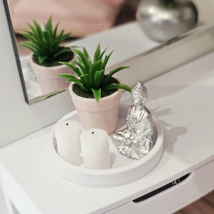 Silver Buddha, two white candles and a green plant in a pink pot on a white tray, 1:12 scale dolls house