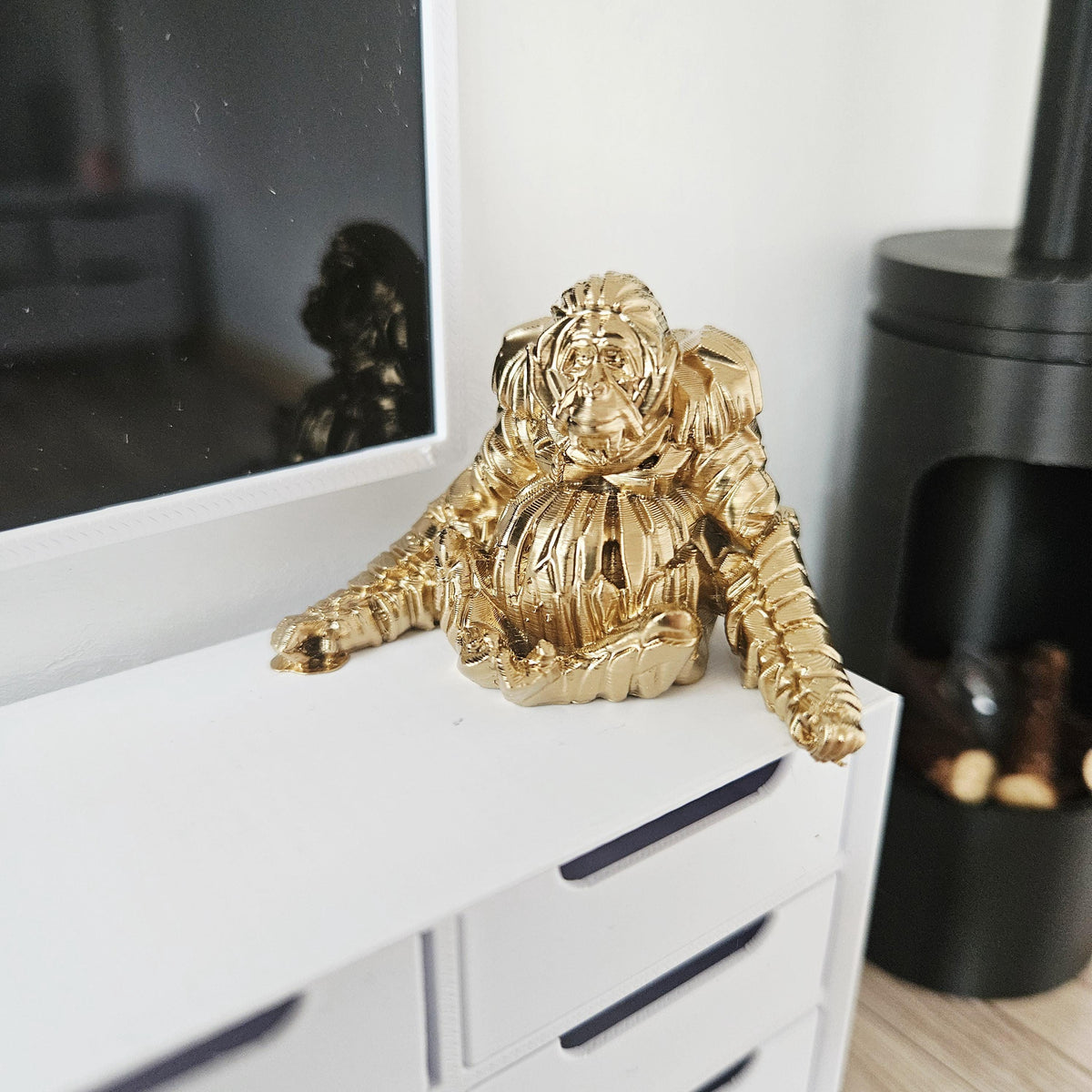 Gold shelf orangutan ornament in a 1:12 scale dolls house display