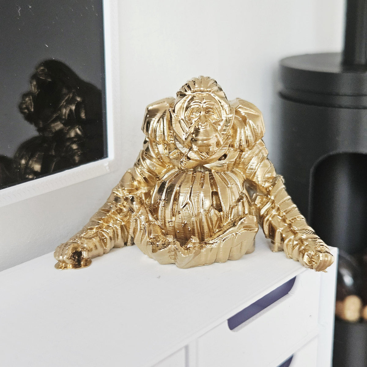Gold shelf orangutan ornament in a 1:12 scale dolls house display, detail view