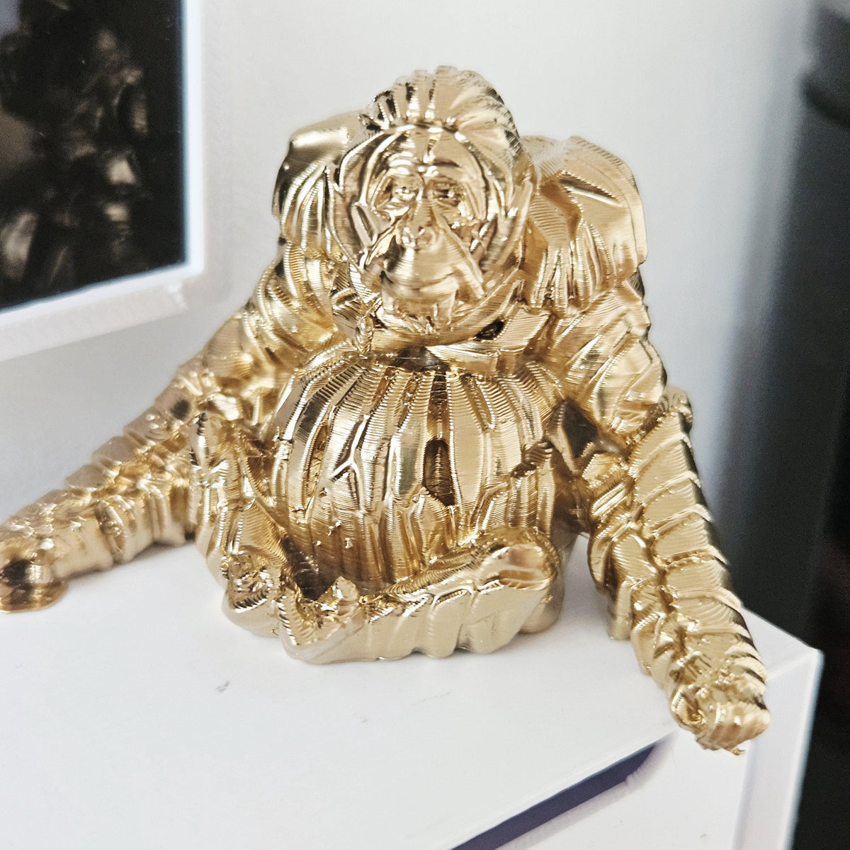 Gold shelf orangutan ornament in a 1:12 scale dolls house display, detail view