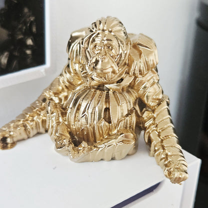 Gold shelf orangutan ornament in a 1:12 scale dolls house display, detail view