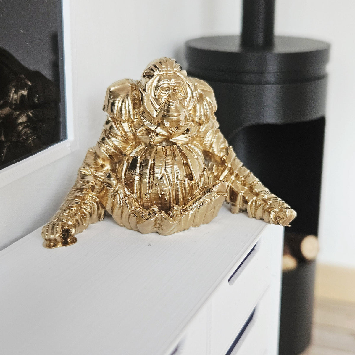 Gold shelf orangutan ornament in a 1:12 scale dolls house display, detail view