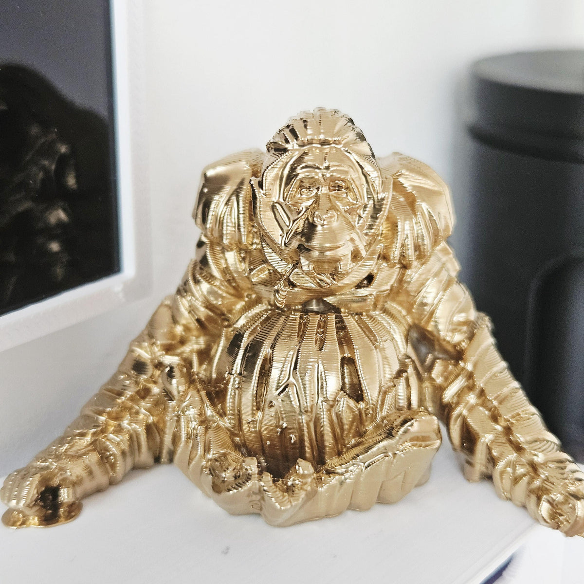 Gold shelf orangutan ornament in a 1:12 scale dolls house display, detail view