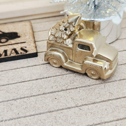 Gold pickup truck carrying a Christmas tree on a dolls house porch, 1:12 scale