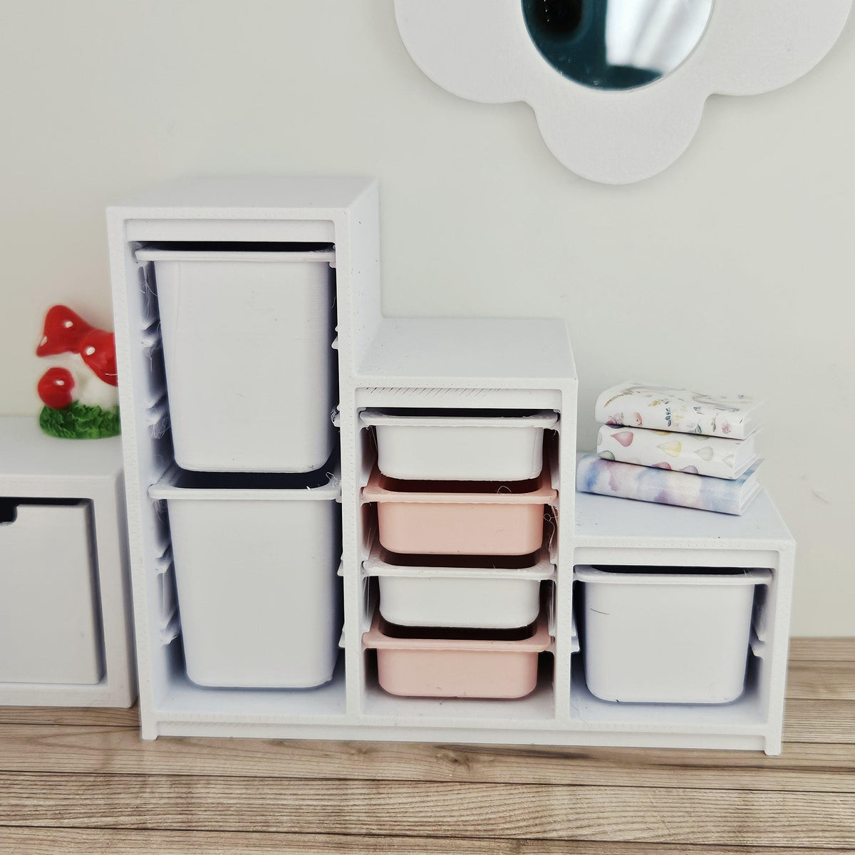 Pink & White storage unit with seven trays & bins in a 1:12 scale dolls house display