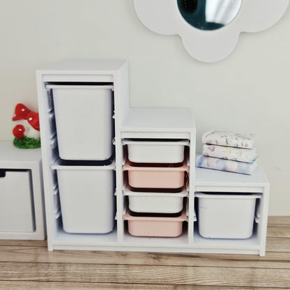 Pink & White storage unit with seven trays & bins in a 1:12 scale dolls house display