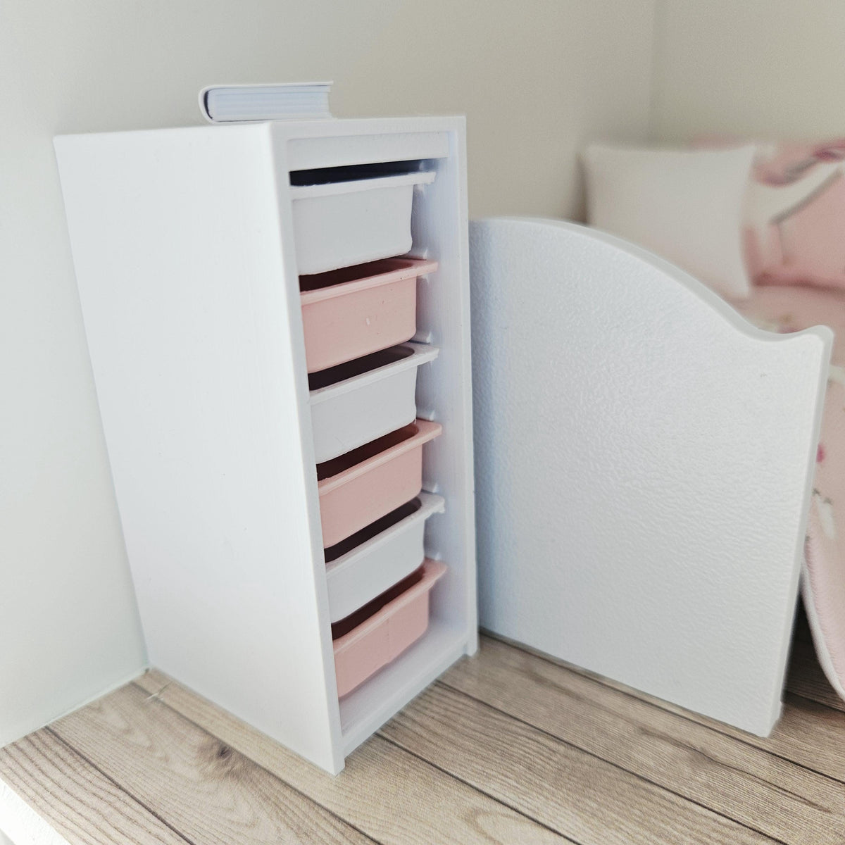 Pink & White storage unit with six boxes in a 1:12 scale dolls house display