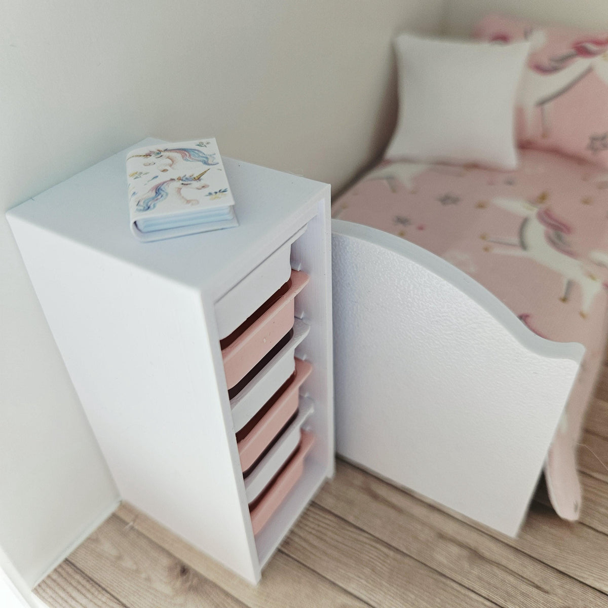 Pink & White storage unit with six boxes in a 1:12 scale dolls house display, detail view