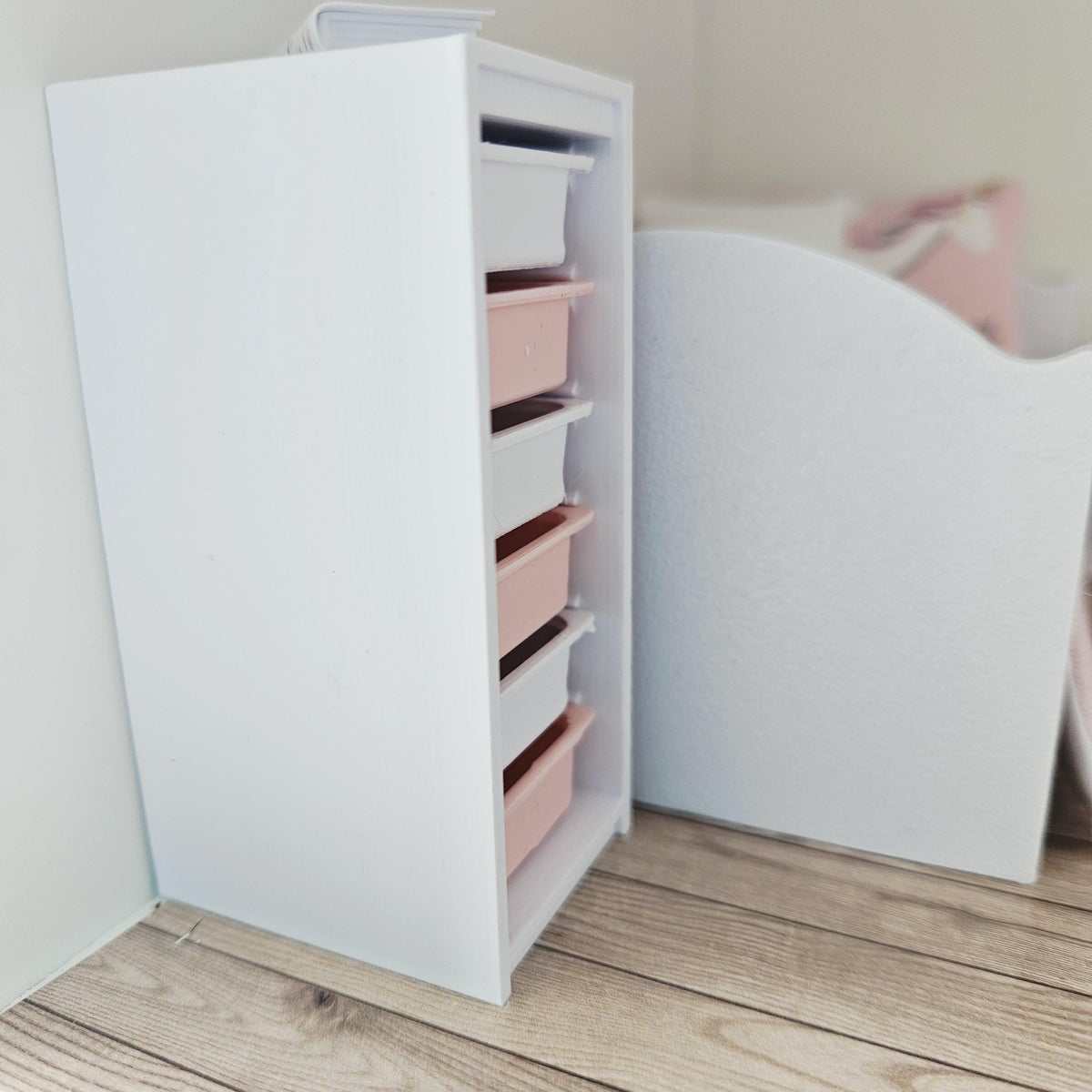 Pink & White storage unit with six boxes in a 1:12 scale dolls house display, detail view