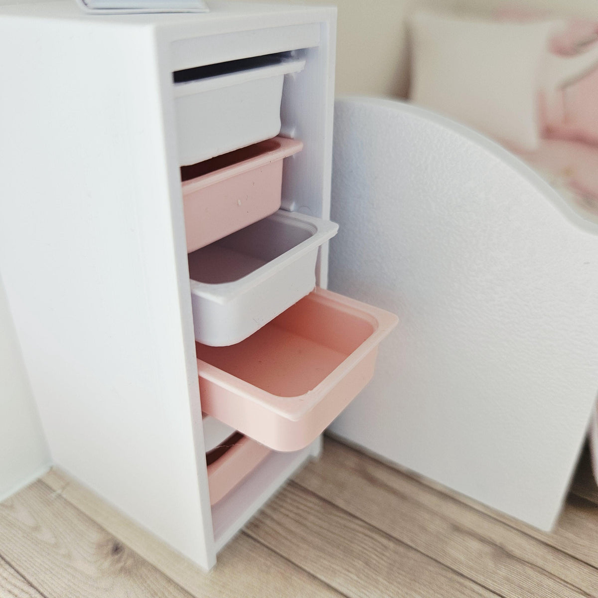 Pink & White storage unit with six boxes in a 1:12 scale dolls house display, detail view