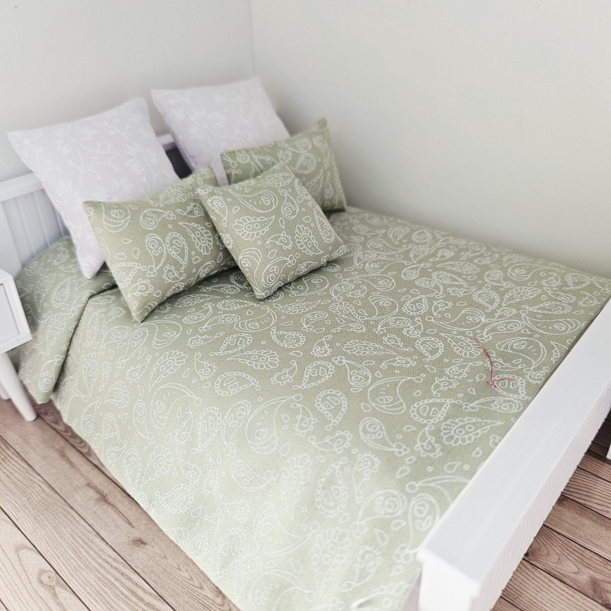 green paisley double bedding set in a 1:12 scale dolls house display