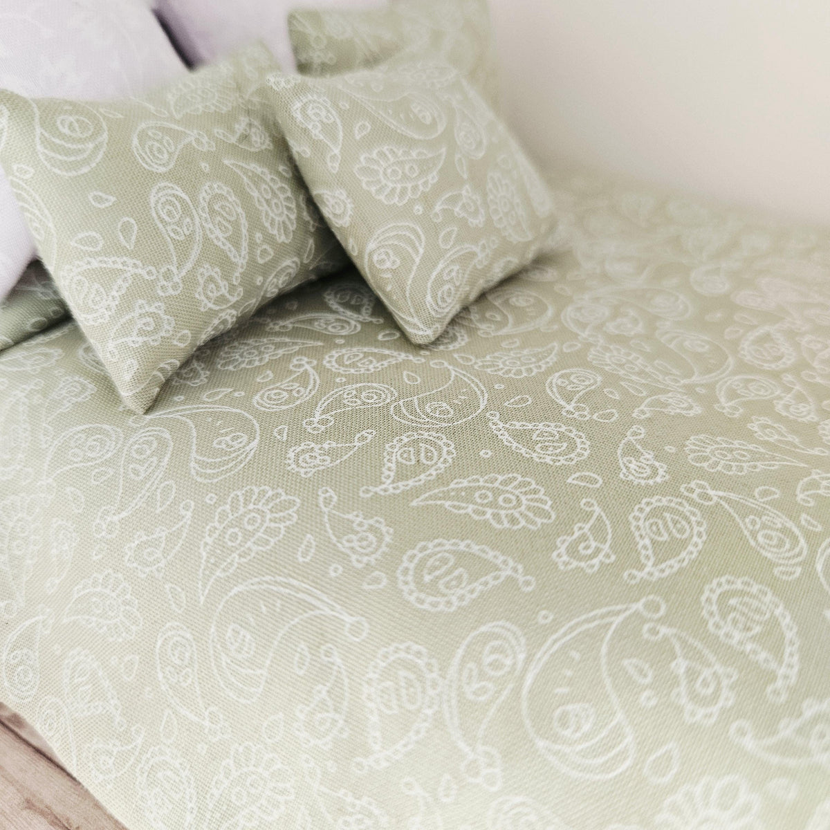 green paisley double bedding set in a 1:12 scale dolls house display, detail view 2