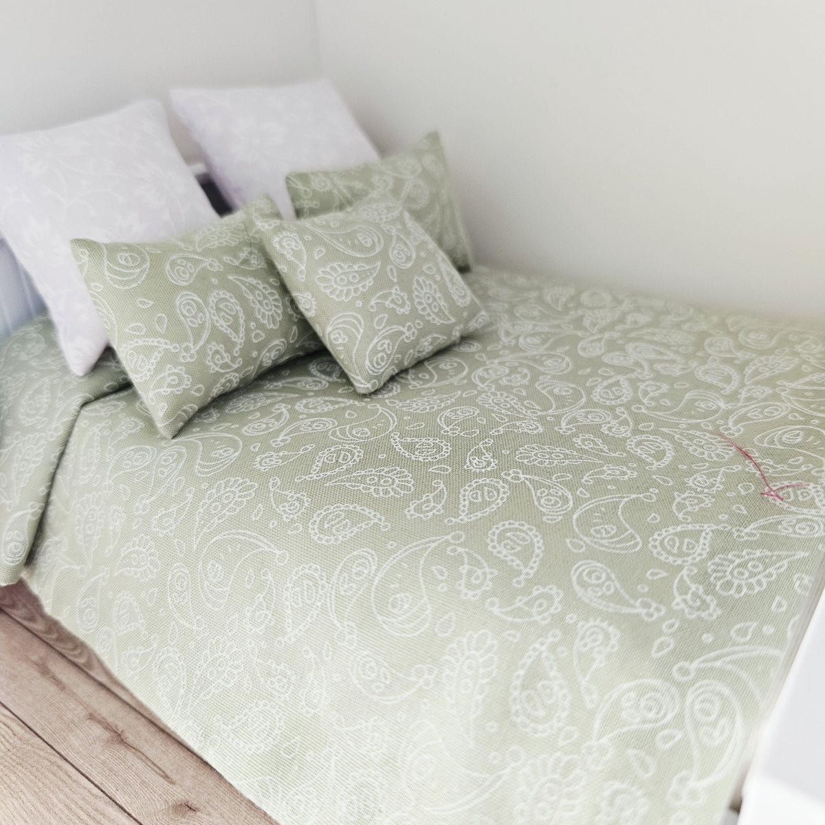 green paisley double bedding set in a 1:12 scale dolls house display, detail view 4