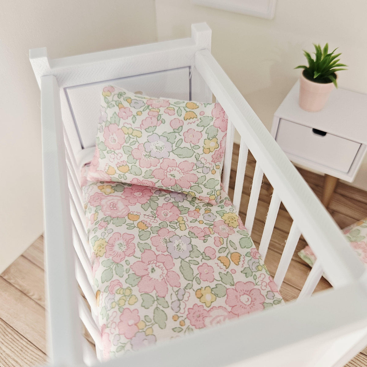 pastel liberty floral cot bedding set in a 1:12 scale dolls house display