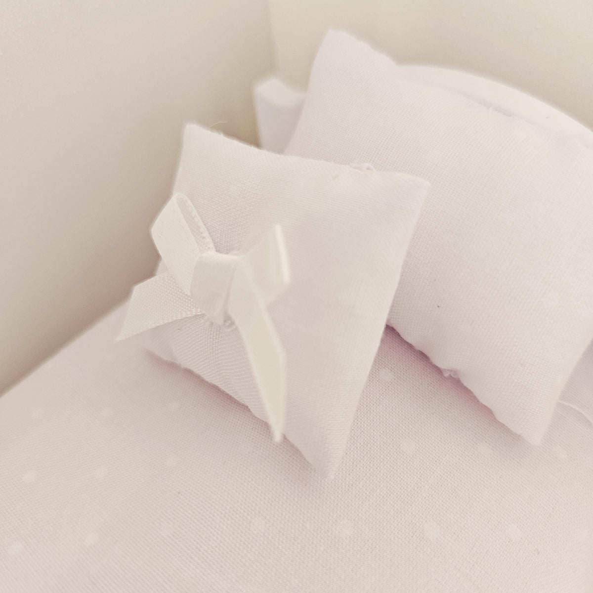 white polka dot junior bedding set in a 1:12 scale dolls house display, detail view 3