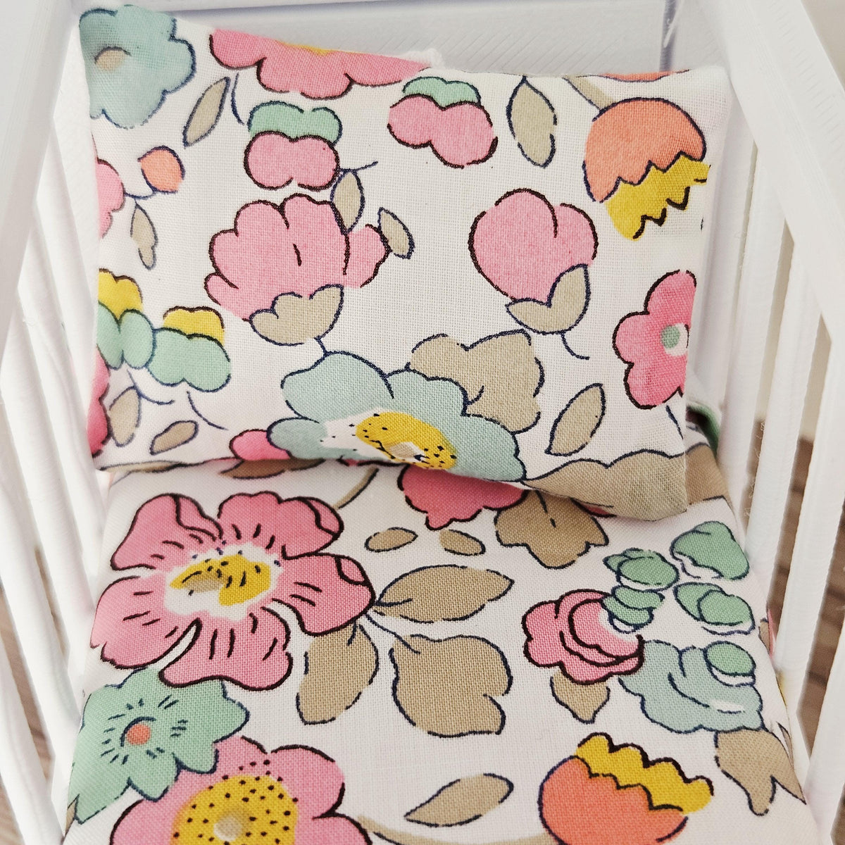 pink & yellow liberty floral cot bedding set in a 1:12 scale dolls house display, detail view 5