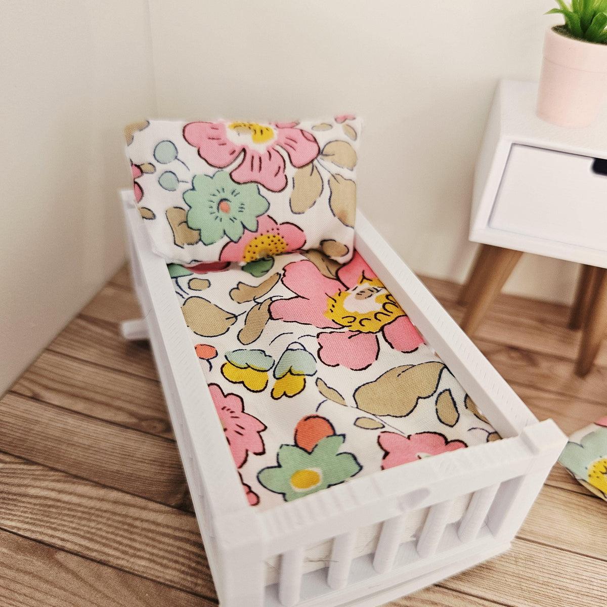 pink & yellow liberty floral crib bedding set in a 1:12 scale dolls house display, detail view 3